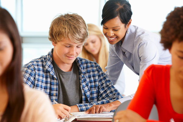 Teacher helping a high school student