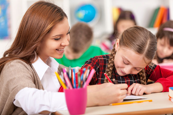 Teacher coloring with a student