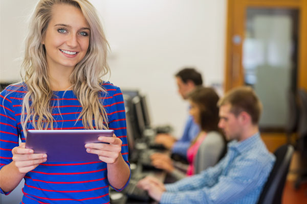 Teacher at the front of a computer lab